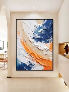 an abstract painting hangs on the wall next to a dining room table