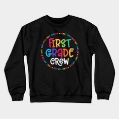 a black sweatshirt with the words first grade crew in rainbow letters and an image of a circle