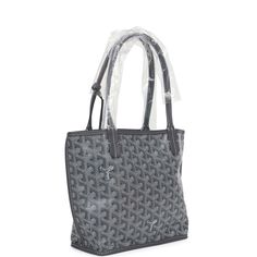 This Anjou Mini reversible tote is of grey Goyardine canvas and leather with palladium hardware and features grey leather handles and trim, removable pouch and contrast white stitching.The interior is lined with grey leather and is reversible.Origin: FranceCondition: New and never worn (plastic on handles)Accompanied by: Goyard dustbag, carebook, felt, detachable pouchMeasurements: 8" x 8" x 4"; 7" shoulder strap Anjou Mini, Goyard Anjou, Hermes Birkin 25, Reversible Tote, Birkin 25, Madison Avenue, Leather Handles, Hermes Birkin, Grey Leather