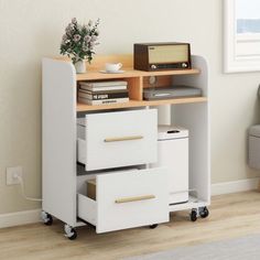 a white desk with drawers and a radio on top of it next to a chair