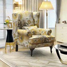 a living room scene with focus on the chair and the footstool in the foreground