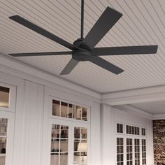 a ceiling fan mounted on the side of a wall in a room with white walls