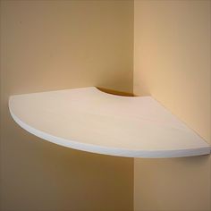 a white shelf mounted to the side of a wall