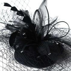 Black Hat with Birdcage Veil Add vintage charm to your wedding or special occasion with this elegant birdcage face veil bridal hat. This wedding headpiece has a gorgeous black flower decorating the top of the hat, with accents of sparkling crystals and sprays of feathers. Size: Flower Feather Accent on Hat Measures 4-1/2" x 7" Wide - Veiling extending off the hat measures 7-1/2" Long - Round Hat Measures 3-3/4." Color: Black. Style: hp8366b. Alligator Clip underneath hat for placement. Perfect f Black Summer Wedding Headpieces, Black Headpiece For Spring Wedding, Adjustable Bridal Accessories For Evening, Black Adjustable Hair Accessories For Wedding, Adjustable Black Hair Accessories For Wedding, Elegant Black Mini Hats As Gifts, Elegant Black Hat As Gift, Goth Wedding Theme, Black Birdcage Veils