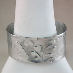 Wide Cuff Bracelet Aluminum Wide Metal Cuff Bracelet - Whimsical Pattern - Textured Cuff Bracelet This is an aluminum cuff bracelet with a whimsical hearts textured pattern pressed in the metal. The cuff bracelet measures 1-1/4" x 6", The bracelet is textured, then the corners rounded, then polished to a high polished - brushed metal finish. This bracelet is VERY light weight, gorgeous and fun to wear. You will love it :) Aluminum is nickel free and hypo allergenic ****************************** Bracelet Wide, Whimsical Heart, Metal Cuff Bracelet, Wide Cuff Bracelets, Cuff Jewelry, Wide Bracelet, Wide Cuff, Brushed Metal, Jewelry Bracelet