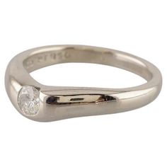 a white gold ring with a single diamond