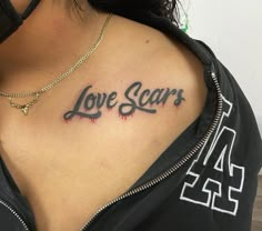 a woman with a tattoo that says love scars on her chest