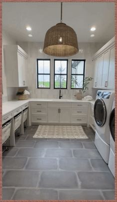 a laundry room with washer, dryer and cabinets in white color combinations