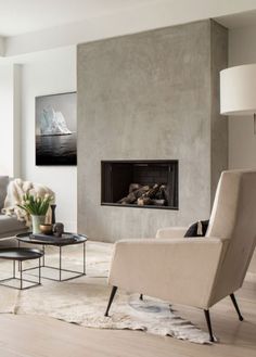 a living room filled with furniture and a fire place next to a wall mounted tv