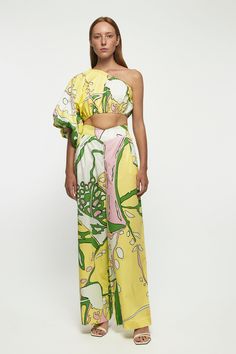 DESCRIPTION Exaggerated One Shoulder Crop - USD 269.00 This printed cropped top will effortlessly take you from the beach to golden hour on vacation. Cut from airy cotton, a romantic sleeve cascades from the one-shoulder neckline and sways in the sea breeze. Style yours with the matching pants. * Prints and colours may vary slightly due to the handmade nature of each piece. Color: Metamorphosis V Front Straight Leg Trouser - USD 279.00 These sorbet printed pants have such a relaxed feel. They're Summer Floral Print Cropped Crop Top, Summer Floral Print Cropped Top, Printed Summer Crop Top, Printed Cropped Summer Crop Top, Summer Printed Cropped Crop Top, Summer Printed Wide Leg Sets, Chic One Shoulder Summer Sets, Chic One-shoulder Summer Set, One Shoulder Crop Top For Summer Day Out