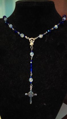 22 Inches around  ,27 inches long cross 2 1/2 in long 2 inches wide  beads ring,eye pins hook,rosary mary  beads -2 cm or smaller ,glass,acrylic Handmade Blue Crucifix Jewelry, Blue Crucifix Necklace For Spiritual Wear, Blue Crucifix Necklace For Spiritual Purposes, Blue Dangle Necklaces With Spiritual Style, Spiritual Blue Dangle Necklaces, Blue Spiritual Necklace, Blue Cross-shaped Jewelry With 8mm Beads, Blue Beaded Rosary As A Gift, Blue Rosary Bracelet For Jewelry Making