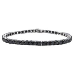 The item in question is a luxurious bracelet adorned with 44 black diamonds, boasting a total weight of 16.50 carats. The diamonds are cut in the brilliant style, which enhances their sparkle and light reflection. The color of the diamonds is a rich black, with an opaque appearance that has been enhanced to achieve a deeper shine. The quality of the cut is regarded as very nice, suggesting that the diamonds have been skillfully shaped to maximize their brilliance. The bracelet is crafted from 14 karat gold, with a hallmark confirming its authenticity. It has a total weight of 17.5 grams, indicating a substantial but comfortable piece. The bracelet measures 18.5 cm in length, making it suitable for most wrist sizes. This item is in new condition, with no visible signs of wear, and the quali Classic White Gold Diamond Bracelet With Black Diamonds, Classic Round Black Diamond Bracelet, Luxury White Gold Diamond Bracelet With Black Diamonds, Elegant Black Diamond Round Bracelets, Elegant Black Diamond Round Bracelet, Formal White Gold Diamond Bracelet With Black Diamonds, Classic Tennis Bracelet With Black Diamonds For Formal Occasions, Formal White Gold Bracelet With Black Diamonds, Elegant Bracelet With Black Diamonds