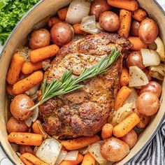 a pot filled with meat, potatoes and carrots on top of a white table