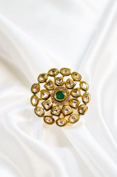 Rinni I - Emerald Finger Ring w/ Meenakari work & Kundan Stones Handcrafted Indian bridal finger ring made with hammered metal and plated with gold. Luxurious emerald stone sits at the centre along with the Kundan stone setting making this ring jewelry one of a kind. Gorgeous floral design Kundans adorns this piece adding grace. A stunning green Meenakari outline enhances this piece making it perfect to be paired with any of your ethnic wear. Stone Setting: Emerald, Kundan & Meenakari Finish: Go Green Indian Dress, Kundan Ring, Gold Wedding Jewelry, Jewelry Indian, Hammered Metal, Stone Setting, Dress Rings, Emerald Stone, Finger Ring