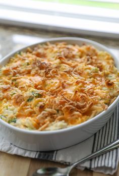 a casserole dish with broccoli and cheese in it on a table