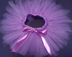 a purple tutu with a pink bow on it