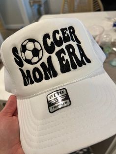 Soccer mom era hat Trucker hat style, white hat, with black stitching White Baseball Cap For Sports Events, White Trucker Hat With Letter Print Visor, White Sports Hat For Baseball Season, White Flat Bill Baseball Cap For Baseball Season, White Sporty Hat For Baseball Season, White Hats For Baseball Season, White Sporty Baseball Hat, White Adjustable Trucker Hat With Visor, Adjustable White Trucker Hat With Visor