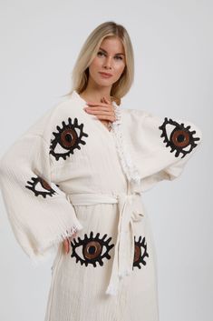 Our Boho Kimono Robe is crafted from 100% natural cotton muslin, making it super soft, fluffy, and breathable. Handwoven and dyed with natural, eco-friendly pigments, this gender-neutral kimono is gentle on your skin and the environment. Perfect as loungewear, beachwear, or a casual throw-on, it’s lightweight, quick-drying, and absorbent. Material: 100% Natural Cotton, OEKO-TEX Certified Artisan Design: Wood block-printed, eco-friendly Size Guide: Loose fit: Fits sizes S-M-L Chest and hip: Up to White V-neck Kimono For Festival, White V-neck Bohemian Kimono, Bohemian V-neck Robe For Loungewear, Bohemian Cream Kimono For Spring, Cream Bohemian Kimono For Spring, White Wrap Robe For Vacation, Cotton Sleep Kimono With Kimono Sleeves, Spring Tunic Kimono For Loungewear, Cotton Kimono With Kimono Sleeves For Sleep