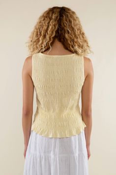 Introducing our Glo Smocked Tank in a light yellow hue. With its smocked texture and boat neck style, it's the perfect elevated basic for spring and summer. Material & Care: Crafted from 97% Rayon and 3% Spandex. Hand wash in cold water with mild detergent. Lay flat to dry. Avoid bleach and dry cleaning. Size & Fit: Model is wearing a size small Summer Tops With Smocked Bodice In Solid Color, Summer Tops With Smocked Bodice, Yellow Smocked Bodice Top For Summer, Spring Smocked Back Top In Solid Color, Spring Solid Color Smocked Back Top, Yellow Smocked Top With Smocked Bodice For Beach, Yellow Smocked Top For Beach Spring Season, Yellow Smocked Top For Spring Beach, Yellow Smocked Top For Spring Beach Outing