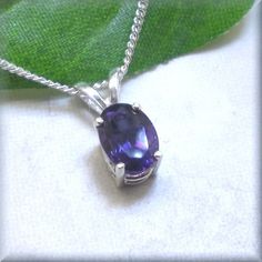 Beautiful African amethyst cut in an oval shape sparkles in it's sterling silver setting. Amethyst is the birthstone for February birthday and this would be a lovely gift idea. Also perfect for anyone who loves the deep calming purple tones of amethyst jewelry. The stone is 7x5mm in size and is a natural African amethyst gemstone. Setting and curb chain are both sterling silver. Items are shown larger in pictures to show detail - please note the dimensions. Jewelry is packaged in a cotton lined Purple Gemstone Necklace With Oval Pendant, Oval Amethyst Cabochon Necklace, Purple Gemstone Oval Pendant Necklace, Amethyst Oval Multi-stone Necklace, Purple Amethyst Oval Pendant Necklace, Gemstone Setting, Necklace African, Silver Items, February Birthday