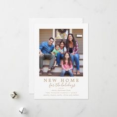 the new home photo holiday card is displayed on a white surface