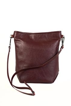 "A beautiful bordeaux leather crossbody bag that is soft to the touch. Lined with interior pocket, adjustable strap, swivel hooks & embossed logo Made in the USA. FEATURES: -11\"L x 10.5\"W x 4.5\"D -Motochap leather exterior; this beautiful natural full grain leather is 1.2mm to 1.4mm thick -Fully lined with soil & stain repellent finish fabric -Interior pocket made with lining fabric -Adjustable matching vegetable tanned leather strap with 18\" handle drop; 5/8\" W -Gunmetal swivel snap tear drop hooks -Magnetic closure -Embossed leather logo -Handmade in the U.S.A. Your great adventure has begun and the Jo Crossbody is right by your side. This wine colored leather crossbody bag boasts an interior pocket and an adjustable strap, leaving your hands free for you to be your own astonishing Burgundy Leather-lined Crossbody Shoulder Bag, Burgundy Leather Lining Crossbody Shoulder Bag, Burgundy Leather Crossbody Shoulder Bag, Formal Burgundy Shoulder Bag With Adjustable Strap, Classic Burgundy Shoulder Bag With Adjustable Strap, Burgundy Leather Bag For Fall, Formal Burgundy Crossbody Satchel, Burgundy Satchel Shoulder Bag With Leather Lining, Burgundy Leather Lined Satchel Shoulder Bag