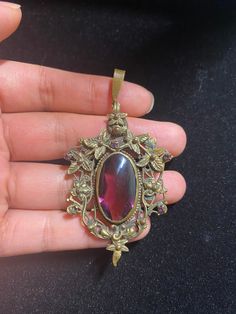 Please see pictures for more details.  Sold as is. Antique Round Amethyst Jewelry, Ornate Jeweled Pendant Jewelry, Antique Jeweled Jewelry For Gifts, Antique Bronze Gemstone Jewelry, Vintage Jewelry With Stone Setting, Antique Gemstone Oval Pendant Jewelry, Antique Oval Pendant Gemstone Jewelry, Vintage Purple Round Jewelry, Antique Amethyst Jewelry Gift