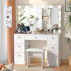 a white dressing table with lights on it