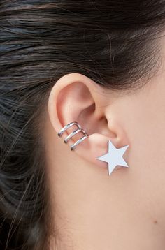 D E T A I L S These Star stud earrings are made of 18k Gold plated /White gold plated copper. These earrings are sold as a pair. The listing is only for the star earrings ( it does not include the cartilage cuff). S I Z E These earrings are approx 0.75x0.75 inch / 2x2 cm C A R E * I N S T R U C T I O N S Remove your jewelry before swimming, bathing, or exercising. Put on your jewelry after cosmetics, perfume, and lotions have been absorbed. Use a soft microfiber cloth to wipe your jewelry after Trendy Silver Ear Cuff With Matching Earrings, Silver Star-shaped Pierced Cartilage Earrings, Minimalist White Single Clip-on Earring, White Minimalist Single Clip-on Earring, Trendy White Ear Cuff, White Star-shaped Metal Jewelry, Silver Star-shaped Cartilage Earrings With Pierced Design, Trendy Silver Star Earrings, Trendy Silver Ear Cuff With Ear Wire