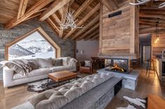 a living room filled with furniture and a fire place in the middle of a room