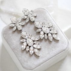 Add a touch of glamour to your bridal look with these luxurious Austrian Crystal Statement Wedding Earrings. Expertly crafted with gleaming and spatkly Swarovski crystals, these timeless earrings will enhance any bridal ensemble. An elegant choice for a truly memorable day.Earrings dangle 3-1/4 inches and are 1-3/8 inch at their widest. PLEASE ALLOW APPROX 10 BUSINESS DAYS FOR COMPLETION BEFORE SHIPPING.Link to videohttps://www.instagram.com/p/B3XSDasDjTW/?igshid=1p6hsj0jvjjbp