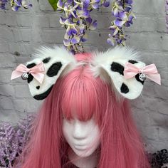 a mannequin head with long pink hair and two bowknots on it