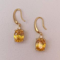 Add a touch of elegance to your look with our Crystal Dangle Drop Earrings! Featuring sparkling crystals, these earrings are perfect for any occasion. Feel confident and stylish while wearing them. Elevate your outfits and express your unique sense of style with our beautiful earrings. Material: Brass Earrings Size: 1.2"x0.4" Elegant Yellow Crystal Earrings For Party, Elegant Yellow Dangle Crystal Earrings, Elegant Yellow Crystal Dangle Earrings, Yellow Gold Crystal Drop Earrings, Wallets For Girls, Citrine Earrings, Wallet Gifts, Sparkling Crystal, Brass Earrings