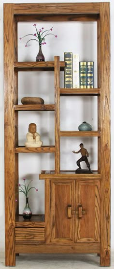 a wooden shelf with some books and vases on it