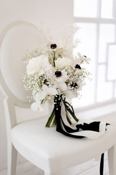 a bouquet of flowers sitting on top of a white chair