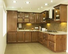 a kitchen with wooden cabinets and tile flooring