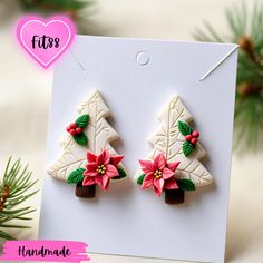 christmas tree earrings with poinsettis on them