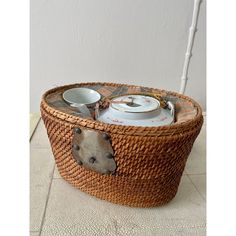 a basket that has some food in it on the floor next to a white wall