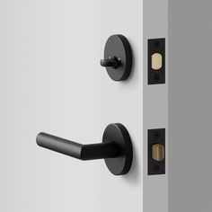 an open door with black handles and knobs