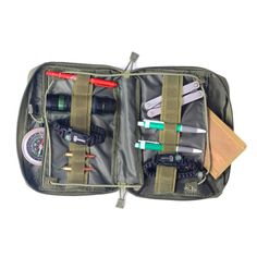 the contents of an outdoor survival kit are neatly packed