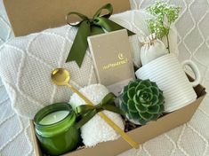 an open box with candles, teacups and other items