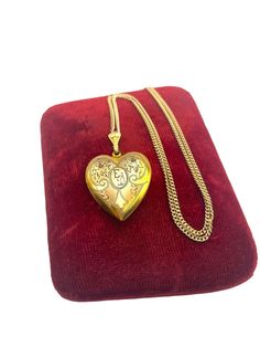 Description: Beautiful vintage 12K gold filled locket.  This locket features etched flowers, leaves and swirling designs on the front with the center an oval and monogrammed initials (I believe they are "ED" but the second letter is open to interpretation).   The fanned bale is decorative and has some nice embellishments that complement the locket front.   The back of the locket is plain with no design. The locket is on the larger side, and is hallmarked WH in one of the wells. This stands for t Traditional Gold Heart Necklace, Traditional Yellow Gold Jewelry For Keepsake, Traditional Yellow Gold Keepsake Jewelry, Victorian Gold Necklaces With Hallmark, Collectible Gold Jewelry With Heart Charm, Gold Heart Cut Locket Necklace For Keepsake, Traditional Gold Keepsake Jewelry, Victorian Gold Heart Pendant Jewelry, Gold Heart Cut Collectible Jewelry