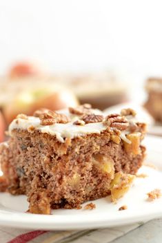 a piece of cake sitting on top of a white plate next to an apple slice