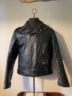 "Vintage Leather Jacket  - Biker style - 1960s vintage  - Buckle strap bottom belt  - Flared zipper sleeves  - Zipper/button pockets  - Buttoned Collar - Rare vintage Grail - Cropped style design  - Clix zipper  Size: L/M 24\" pit to pit  26\" shoulder to waist  25\" sleeve  Great vintage condition  No rips or holes  No stains" Vintage Black Outerwear With Zipper Closure, Retro Winter Biker Jacket With Zipper Closure, Retro Fitted Outerwear With Zipper Closure, Retro Fitted Biker Jacket With Long Sleeves, Retro Fitted Long Sleeve Biker Jacket, Vintage Leather Jacket With Zip Fly, Vintage Leather Jacket With Long Sleeves And Zip Fly, Vintage Biker Jacket With Zip Fly For Fall, Vintage Leather Jacket With Long Sleeves