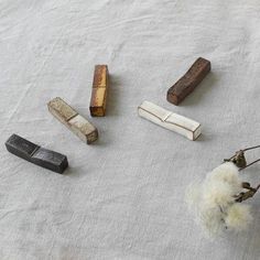 several different types of tools are laying on a white sheet with some cotton in it