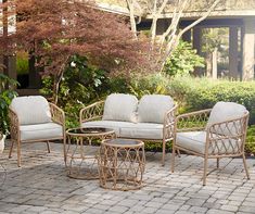 a set of patio furniture sitting on top of a brick floor