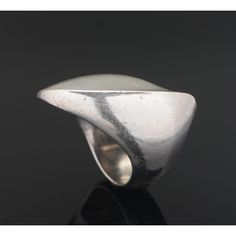 A nanna ditzel for georg jensen sterling silver ring. Designed as a curved undulating sculptural form. It sits beautifully on the finger, catching light from different angles. The ring size is 16/56. Its signed 'georg jensen, 925, denmark, 91    weight: approx. 15 grams.  nanna ditzel (1923 - 2005) is regarded as one of denmark’s most accomplished midcentury designers and she was the first woman to design for the georg jensen silversmithy in 1954. Her work has been exhibited at the metropolitan Sculptural Jewelry With Polished Finish For Formal Occasions, Modern Curved Rings With Polished Finish, Formal Sculptural Silver Jewelry, Modern Sculptural Jewelry, Modern Sculptural Jewelry With Polished Finish, Modern Silver Concave Dome Ring, Modern Silver Dome Ring With Concave Shape, Georg Jensen Jewelry, Nanna Ditzel