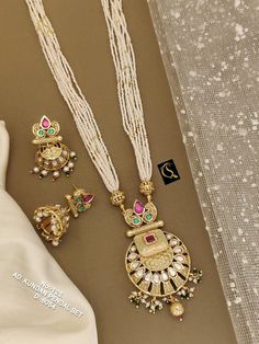 Description :- Antique Temple Pendant Set With Matte Gold Plating, One Gram Gold Necklace, Indian Jewelry, Temple Jewelry, Temple Necklace, South Indian Gift yourself a royal look with this perfectly crafted kundan necklace set from Manalisstudio. Crafted with high quality kundan stones and pearls, it is impressive in design. The green enamel artwork adds perfect texture to the design. Perfect for weddings and festivities, this antique necklace set should be put on with your favorite sari or lehenga. 100% Satisfaction. Long Lasting Plating, High-Quality Stones. Gifting :- This necklace and earring set comes in a beautiful manalisstudio gift box, making it an ideal gift for birthdays, weddings or anniversaries. Occasion :- Perfect choice for any Indian occasion. Care :- It is advisable that White Temple Jewelry Necklaces For Jewelry Making, White Temple Jewelry Necklaces, Handmade White Temple Jewelry Necklace, Handmade White Temple Jewelry Bridal Necklace, Handmade White Bridal Temple Jewelry Necklace, White Round Necklaces For Festivals, White Traditional Kundan Necklace For Jewelry Making, Handmade White Temple Jewelry Necklaces, Gold Kundan Necklace For Anniversary, Handmade