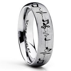 an engraved wedding ring with the word love and heartbeats in black lettering on it