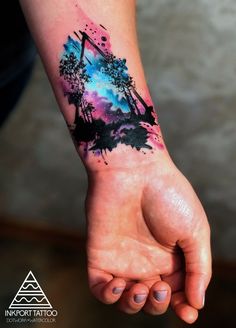 a person's arm with a watercolor painting on it